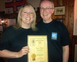 Jo and Richard Bennett receiving the Pub of the Year Award.