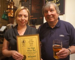 Becky Oliver, licensee of the No Sign Bar, receives the Swansea Camra Pub of the Year award from branch chairman Colin Smith.