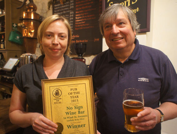 Becky Oliver, licensee of the No Sign Bar, receives the Swansea Camra Pub of the Year award from branch chairman Colin Smith.