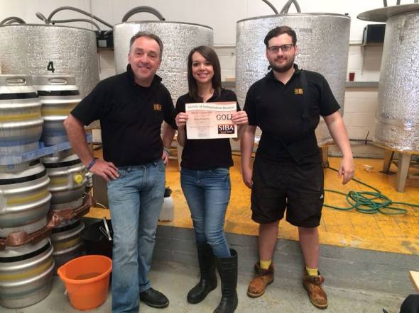 Sarah John (centre) and staff with the SIBA award. 