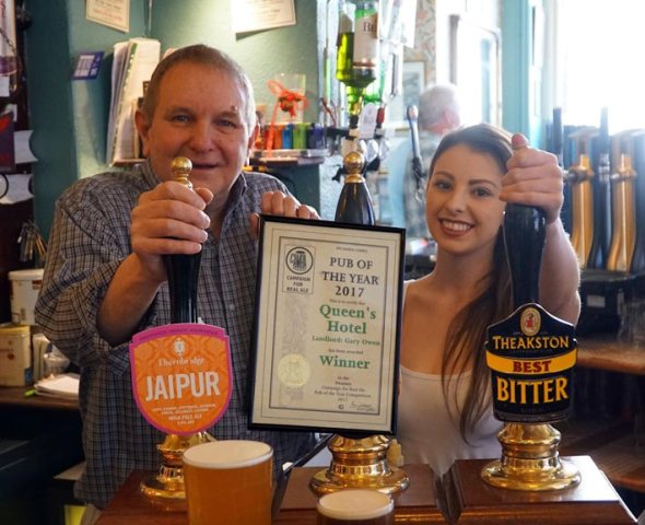 Pulling the perfect pints for which the Queens is famous.