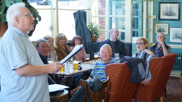 Swansea Camra members listen as branch chairman Paul James makes the award speech.